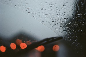 rain and taillights through a windshield on a gloomy day