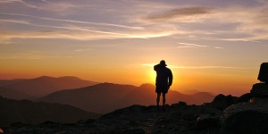 man standing on top of a mountain