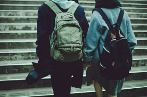 holding hands in front of a staircase
